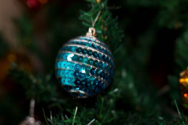 XXXL photo of a red white and blue christmas...stars hanging from a blue ornament with red and white striped ribbon, suggestive of the American Flag, on a sparkle glitter background.  Selective focus on the higher star.