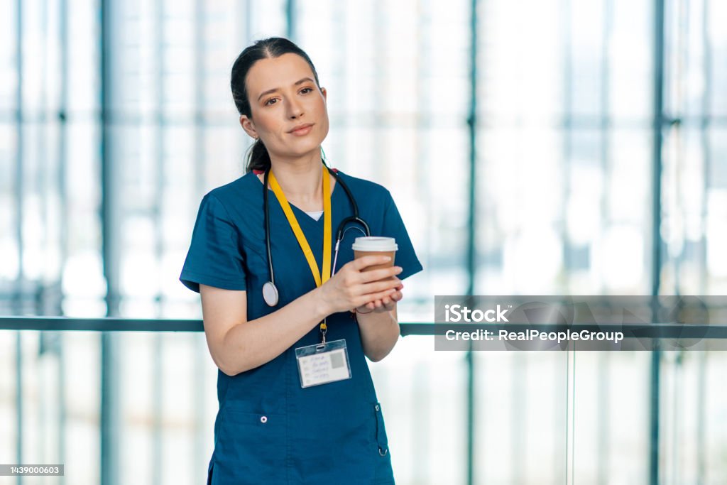 A little break from a busy day Beautiful young Caucasian healthcare worker taking a moment, resting while drinking coffee 25-29 Years Stock Photo