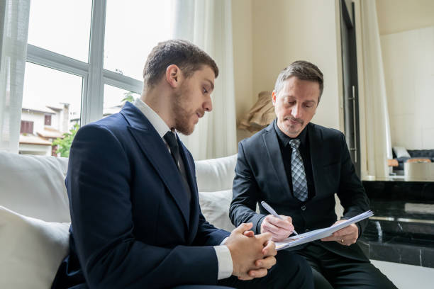 istock Father and son checking documents in luxury room 1439001203