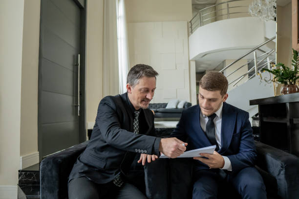 istock Father and son checking documents in luxury room 1439001251
