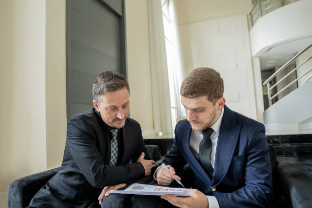 istock Father and son checking documents in luxury room 1439001283