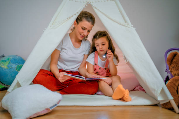 istock Mom and daughter reading a book 1439002077