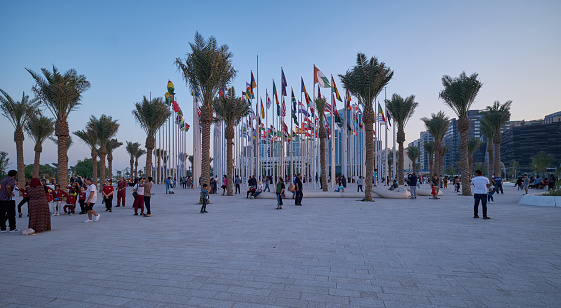 Doha corniche sunset view showing flags of the participating countries with people celebrating. Qatar preparation for FIFA world cup 2022