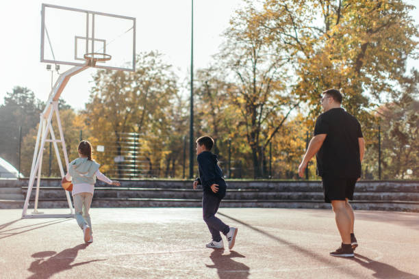 istock Father playing basketball with his children 1439006333