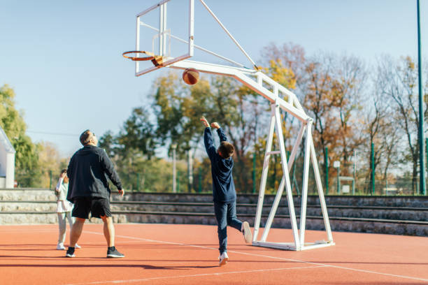 istock Father playing basketball with his children 1439006510