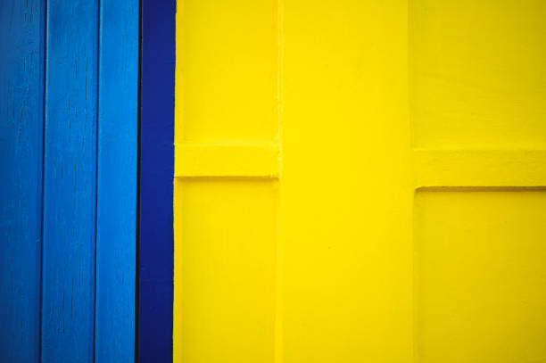 abstract texture of a colorful blue and yellow wall.