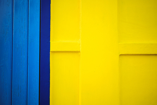 abstract texture of a colorful blue and yellow wall.