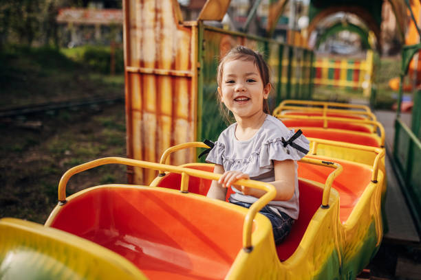 istock Little girl riding is amusement park 1439008549