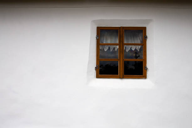 istock Old window on the background of a white wall. 1439009367
