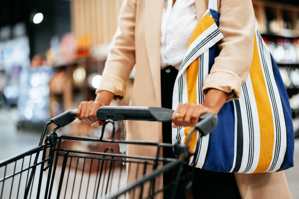 istock Anonymous Woman in a Coat Pushing a Shopping Cart 1439010438