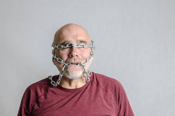 A bearded white man with freckles on his face looks away and smiles. Portrait of happy and happy farmer close-up.