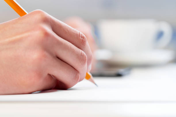 istock A young student studying with a mobile phone and a pencil 1439025142