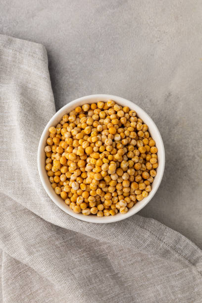 istock A bowl of yellow dry peas on a light background 1439026248