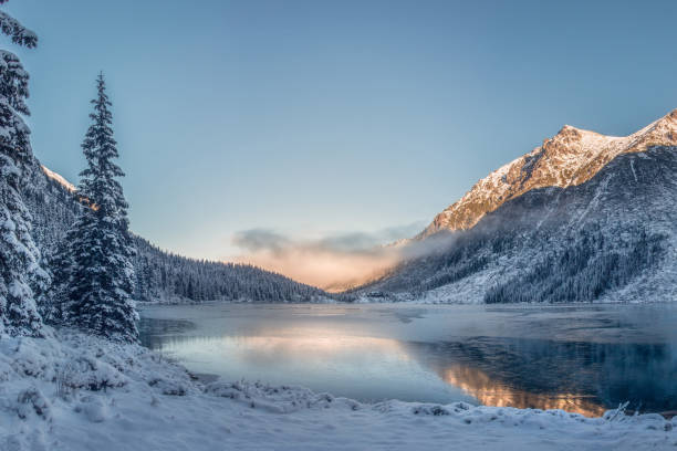 Sunrise above lake in Tatra mountains. stock photo