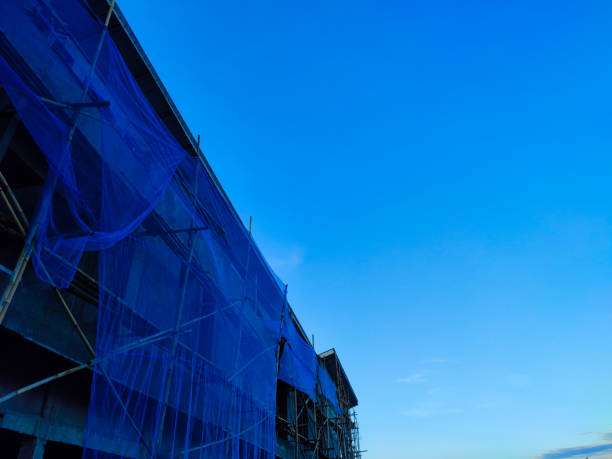 Building structure with bamboo ladder against clear blue sky in the morning.