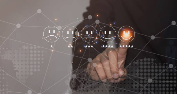 istock A Businessman is Touching Smiley Face Emoticon on Virtual Screen to Give Satisfaction. 1439030852