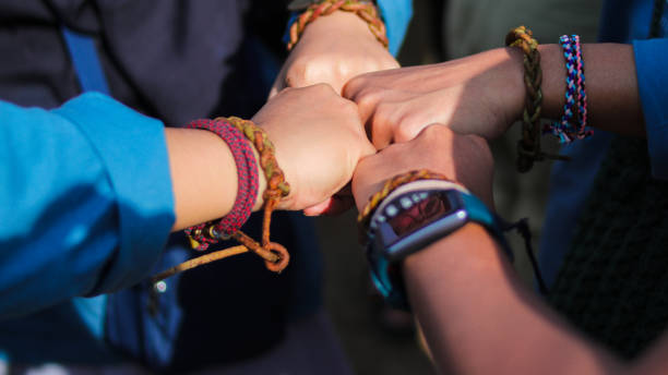istock Group of young people making a fist bump gesture 1439031089