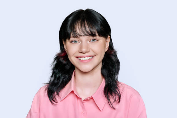 istock Smiling young female looking at camera on light background 1439031150