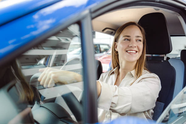 istock Young woman driving car and enjoying 1439031640