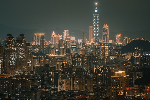 Hong Kong skyscrapers skyline cityscape view from Victoria Peak illuminated in the evening. The most famous view of Hong Kong at twilight sunset. Hong Kong, special administrative region in China