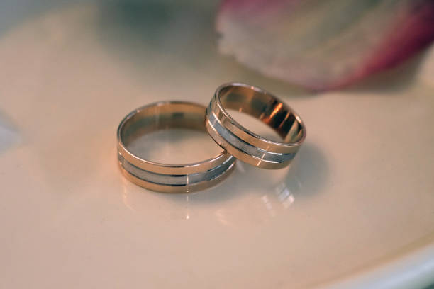istock Wedding rings on a white saucer 1439046960