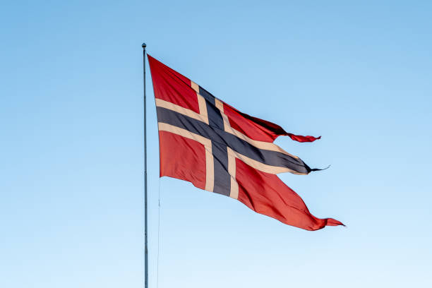 istock A waving Norwegian swallowtail flag with blue sky in the background. 1439051704
