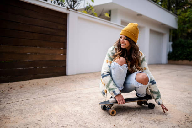 Young adult woman skateboarding stock photo
