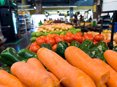 Carrots, peppers, chayote, tomatoes fresh in the supermarket. Vegetables and fruits exposed for the consumer to choose.