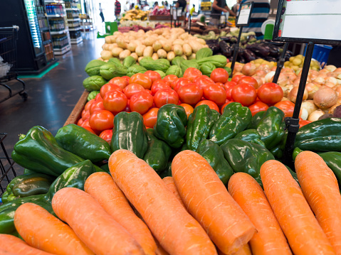 Carrots, peppers, chayote, tomatoes fresh in the supermarket. Vegetables and fruits exposed for the consumer to choose.