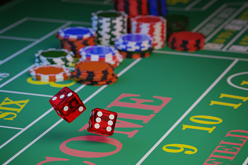 A pair of dice rolling down a craps table with copy space. Selective focus.Gambling concept. 3d illustration.