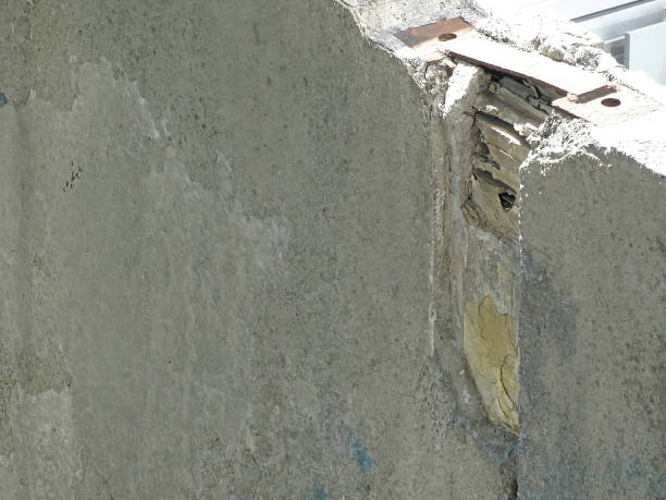 istock Hole in concrete wall demolition, bullet hole, abstract background 1439075402