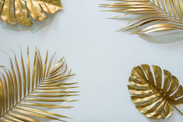 istock Gold tropical palm leaves Monstera on white background. Flat lay, top view minimal concept. 1439093321