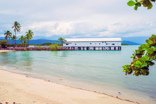 A view looking across the small bay to the historical boathouse building at the tropical holiday town of Port Douglas Far North Queensland.