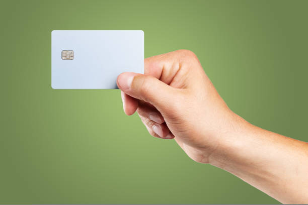 istock Man's hand holding credit card. 1439100634