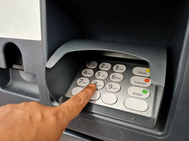 istock hand pressing the ATM machine keyboard button to enter the PIN number or pass code into the ATM machine 1439104583