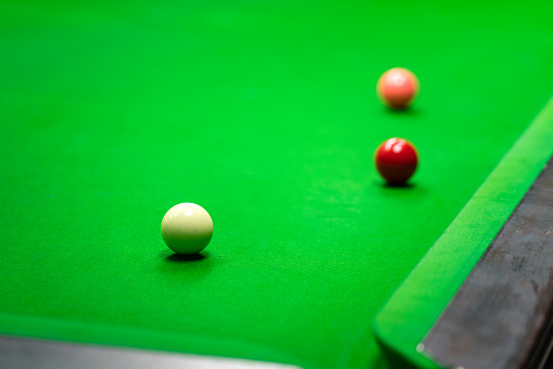 Snooker cue and pool balls over pool table. Directly above. Horizontal composition with copy space. Snooker concept.