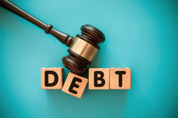 istock Gavel and wood block with DEBT 1439123421