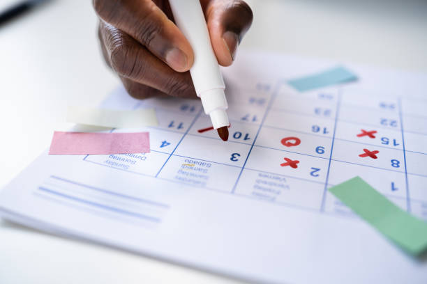 istock Calendar Deadline. Young Man Holding Pen Marking 1439125310