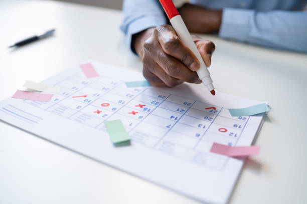 istock Calendar Deadline. Young Man Holding Pen Marking 1439125314