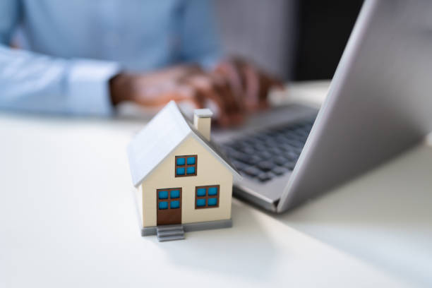 istock Real Estate House Model Near Laptop 1439125347