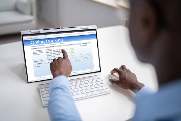 istock Young Happy African Businessman Doing Online Banking On Computer 1439125456