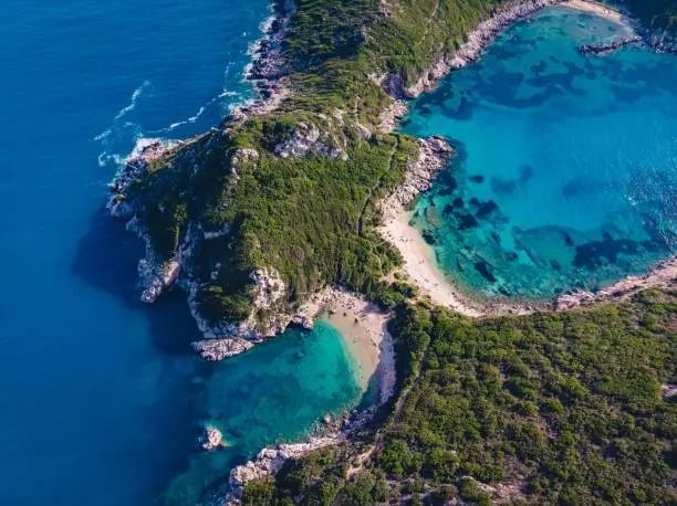 Aerial drone shot of breathtaking shore of Porto Timoni with deep tropical blue and clear turquoise sea, Corfu island, Ionian, Greece