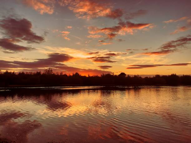 istock Beautiful scenery of sunset over a lake 1439131123