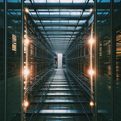 A vertical shot of an illuminated data center storage and network server room