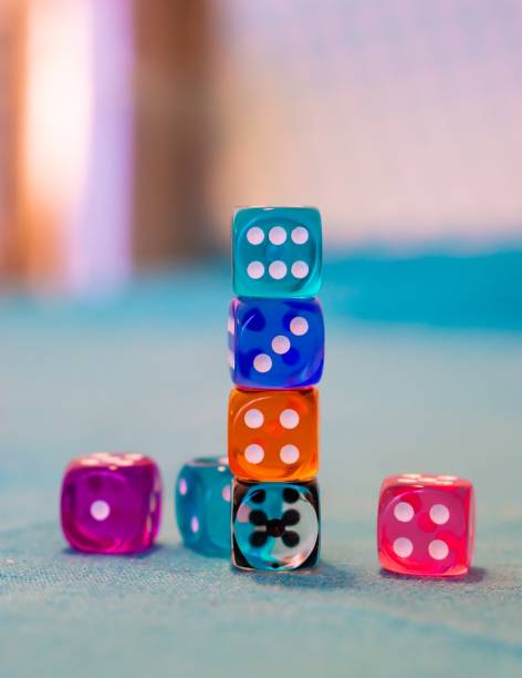 istock Vertical shot of colorful game dices on a blue table 1439134083