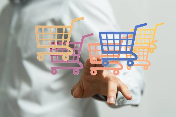 istock Human hand presenting the digital projection of shopping carts 1439134696