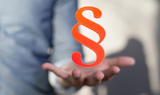 istock Lawyer working with a virtual projection of a digital paragraph law symbol 1439136472
