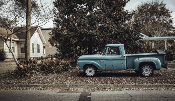 istock Blue compact van parked under the tree in front of a house 1439136751