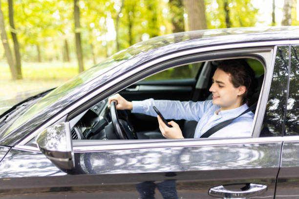 istock Man driving car and texting on the cellphone while drive 1439137037
