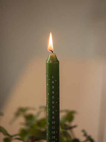 Modern christmas advent candle light \nPhoto taken indoors at  home